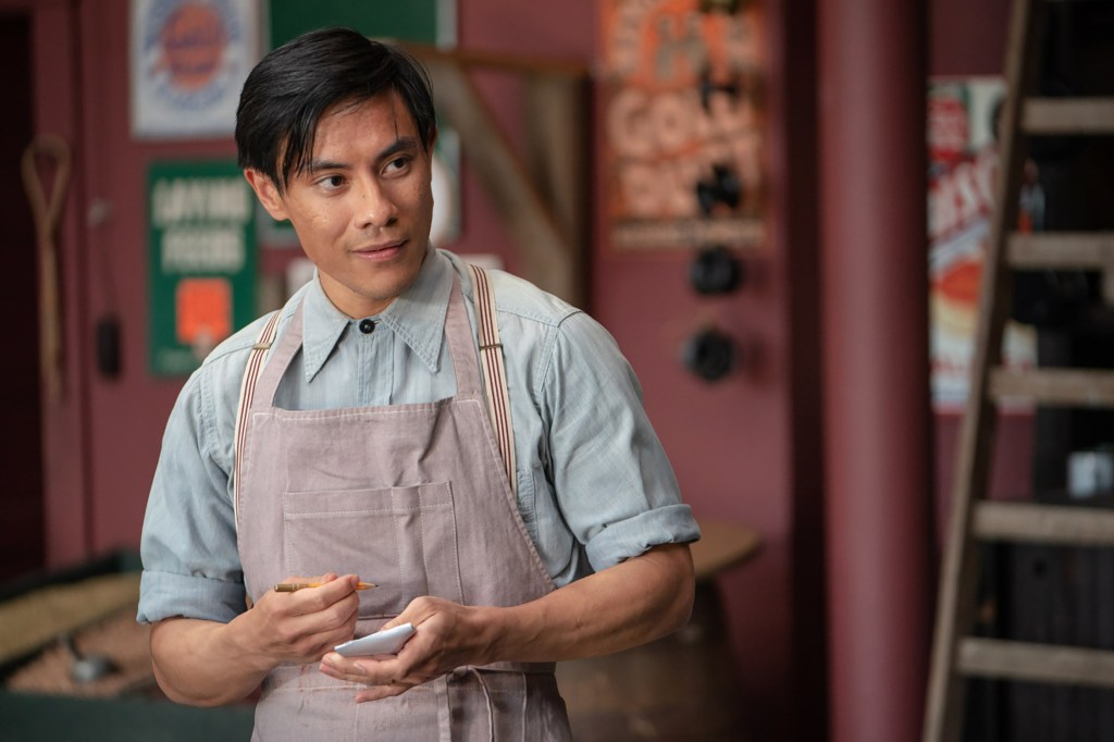Bo Chow wearing an apron inside of his grocery store.